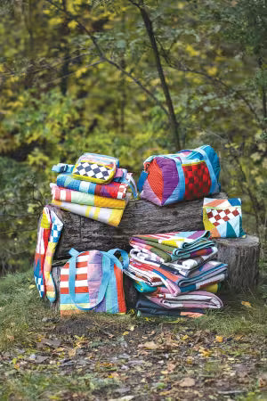 Inside cover of Modern Improv Quilting by Laura Veenema featuring a vibrant, abstract improvisational quilt design.