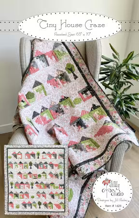 Front cover of the 'Tiny House Craze' quilt pattern by Jill Finley for Jillily Studio, showcasing a completed twin-size quilt featuring a grid of colorful, scrappy log cabin house blocks interspersed with simple appliqued green trees and shrubs.