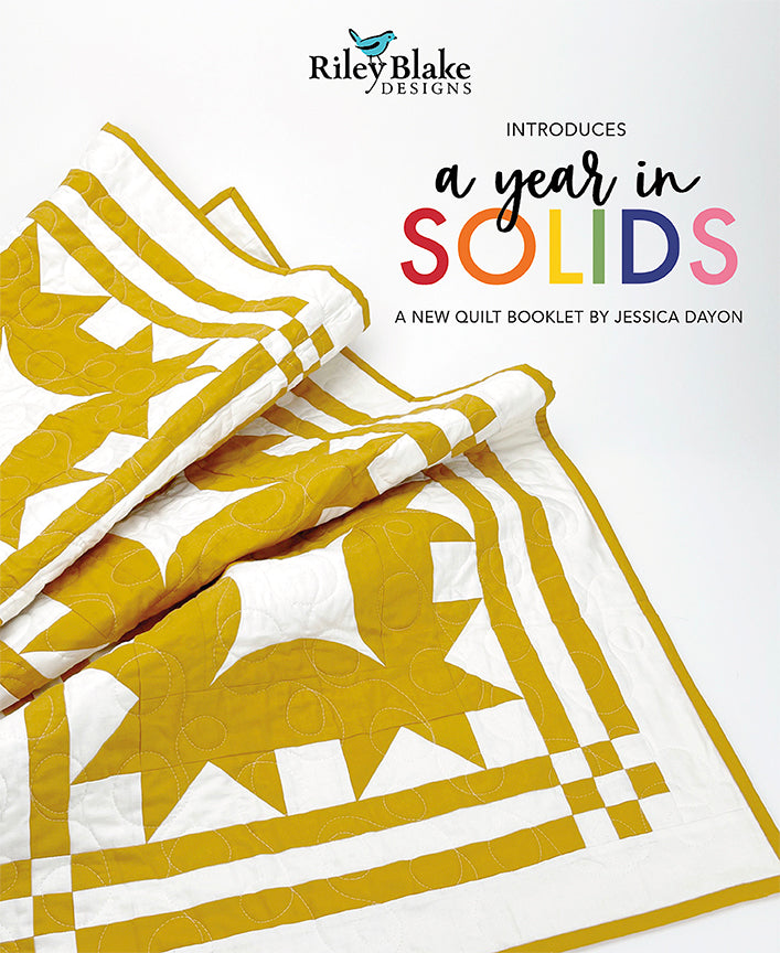 Front cover of A Year in Solids quilt pattern book by Jessica Dayon, featuring colorful modern quilts made with solid fabrics.