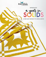 Front cover of A Year in Solids quilt pattern book by Jessica Dayon, featuring colorful modern quilts made with solid fabrics.