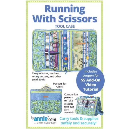 Front cover of the ByAnnie 'Running with Scissors' sewing pattern, showing a structured rectangular tool case unzipped and laid flat to display multiple clear and mesh pockets filled with colorful sewing notions and scissors.