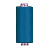 Spool of blue Riley Blake Confetti Cotton 60wt thread on a pink WonderFil Efina core, 1500 yards of premium Egyptian cotton.