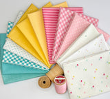 A fanned-out fabric bundle featuring Riley Blake Designs Basics in a palette of teal, yellow, pink, and white prints including checkers, stripes, and dots.